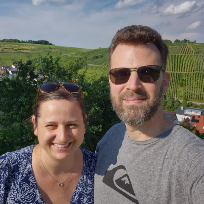 Foto von Claudia und Bernd Heinen vor den Weinbergen von Beckstein.